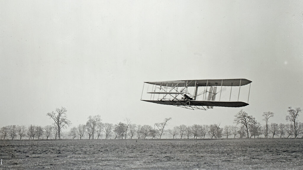 Orville in flight over Huffman Prairie in Wright Flyer II. Flight 85, approximately 1,760 feet (536 m) in 40.5 seconds, November 16, 1904